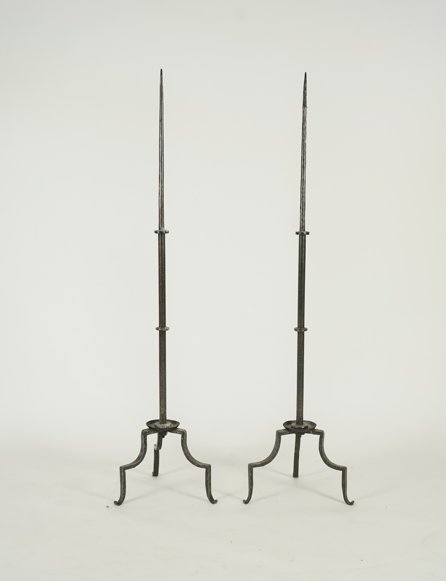 A pair of standing iron pricket candlesticks